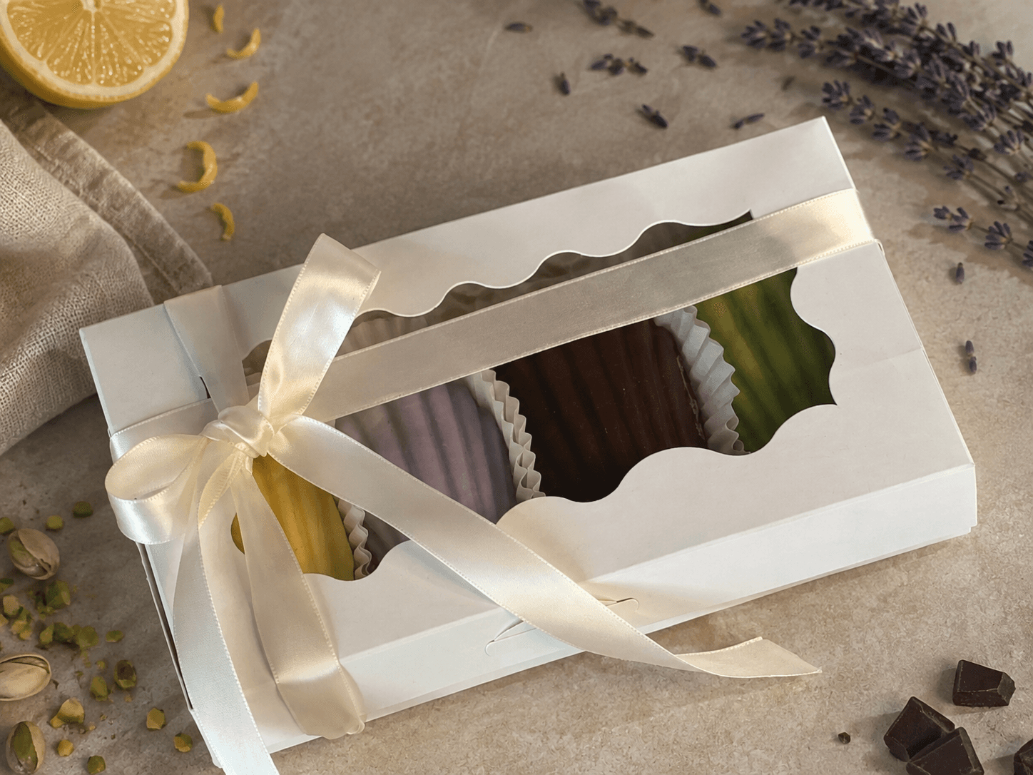 Madelia madeleines in a windowed gift box tied with an ivory ribbon